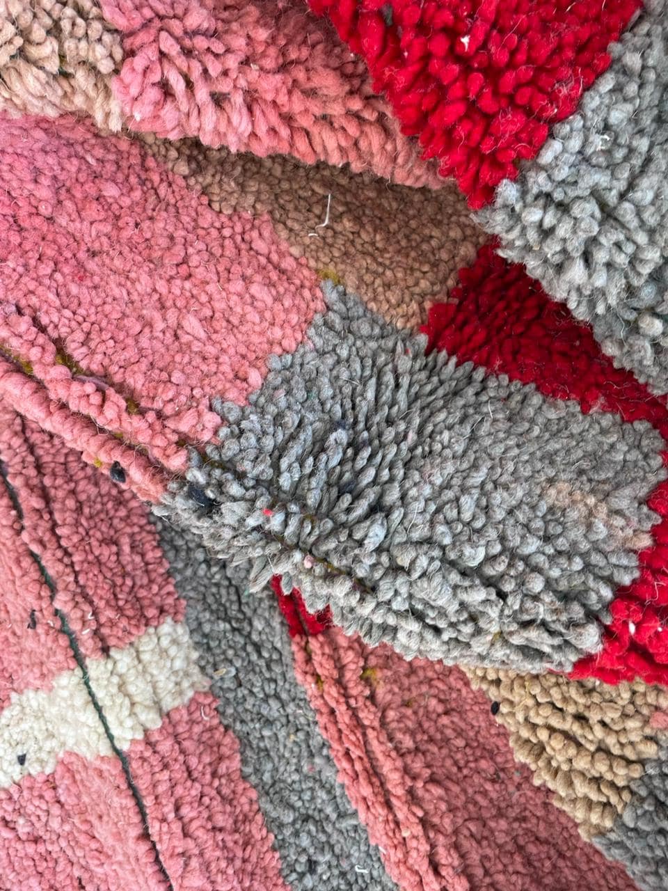 Close-up detail of tribal patterns on the pink Moroccan rug.