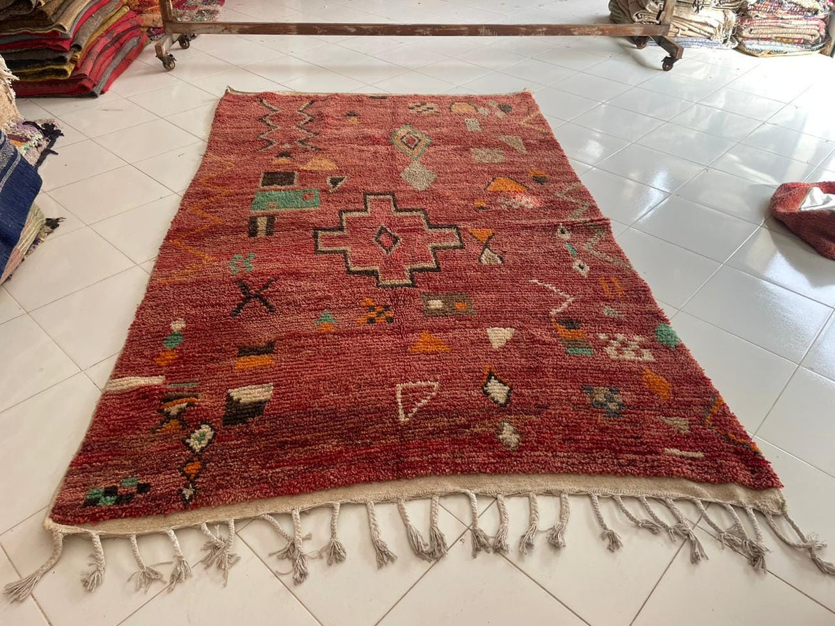Top view of a red Moroccan rug showcasing its vibrant colors and large area design.