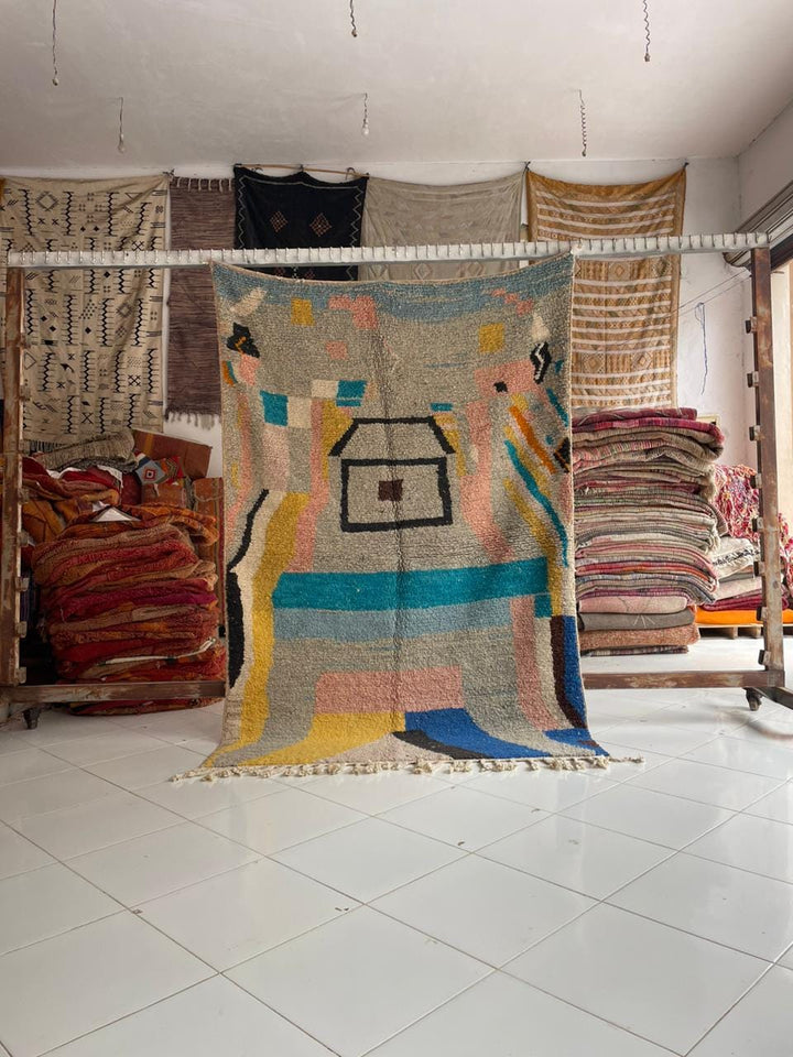 Lifestyle shot of a colorful Moroccan rug with geometric patterns in a natural setting.