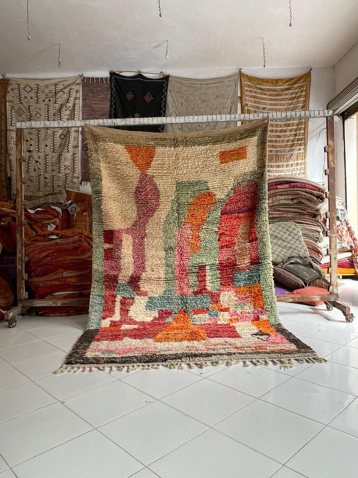 Lifestyle shot of a colorful Moroccan rug featuring bohemian style and fringed edges.