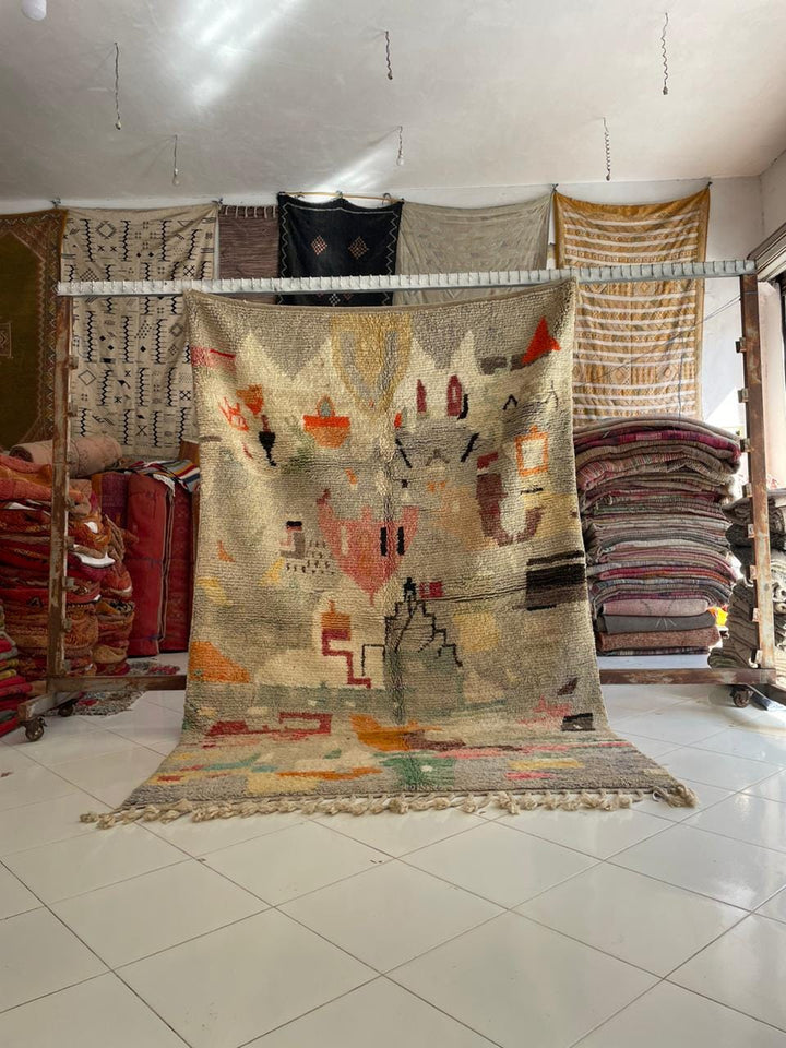 Lifestyle shot of a colorful Moroccan rug with beige, red, green, and orange hues.