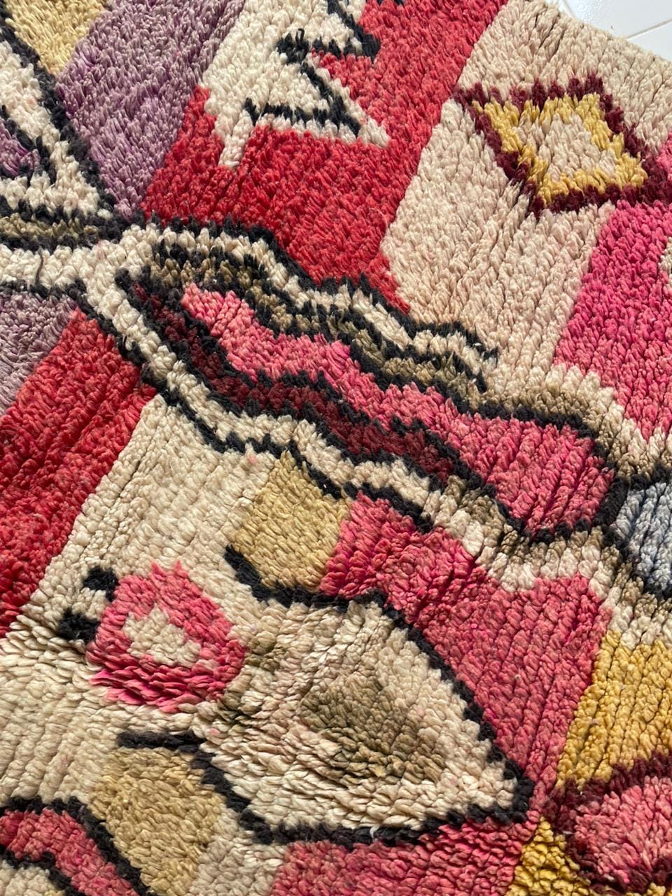 Close-up of a colorful Moroccan rug showcasing abstract patterns and a soft texture.