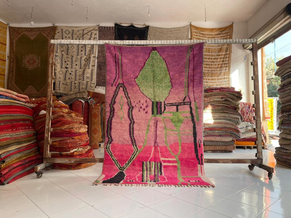 Lifestyle shot of a pink Moroccan rug in a natural setting, featuring a vintage design.