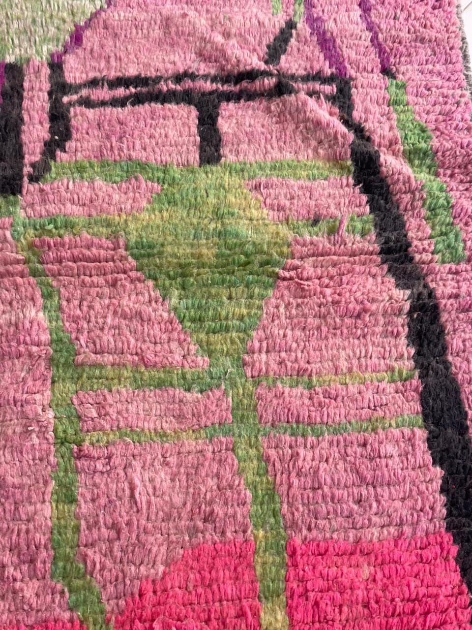 Detailed close-up of a pink Moroccan rug highlighting colorful patterns and texture.