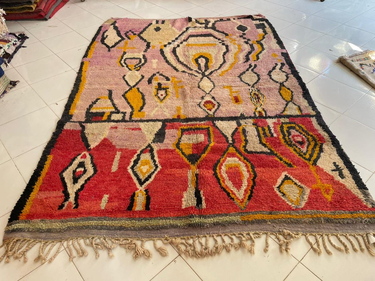 Front view of the pink vintage Moroccan rug featuring intricate patterns and a large area design.