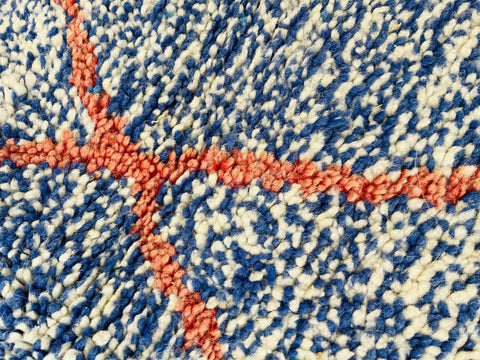 Close-up of the abstract design on the blue and red Beni Ourain Moroccan rug.