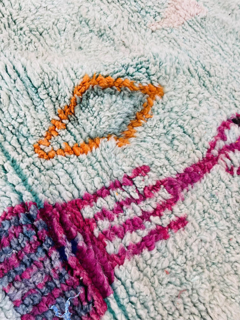 Close-up of the abstract pattern on the blue and red Beni Ourain Moroccan rug.
