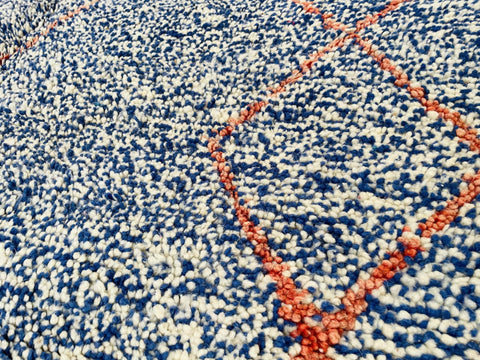 Detailed view of the abstract pattern on the blue and red Beni Ourain Moroccan rug.