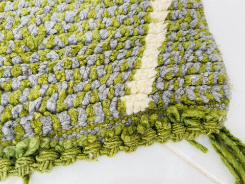 Top view of the green and grey rug showcasing its diamond pattern.