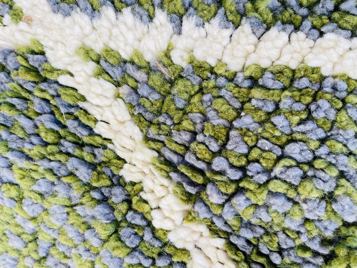 Close-up detail of the abstract pattern and textured surface of the rug.