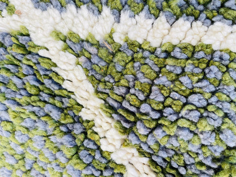 Close-up detail of the abstract pattern and textured surface of the rug.