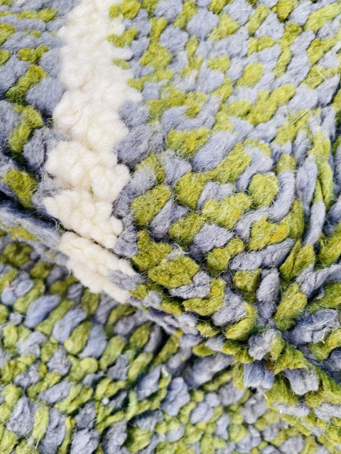 Close-up detail of the textured surface and color variation of the rug.