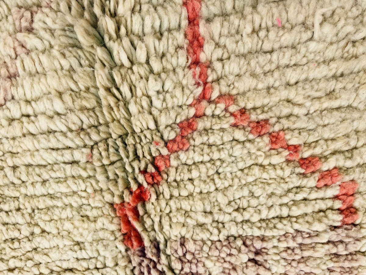 Detail shot of the textured weave of the orange geometric Beni Ourain Moroccan rug.