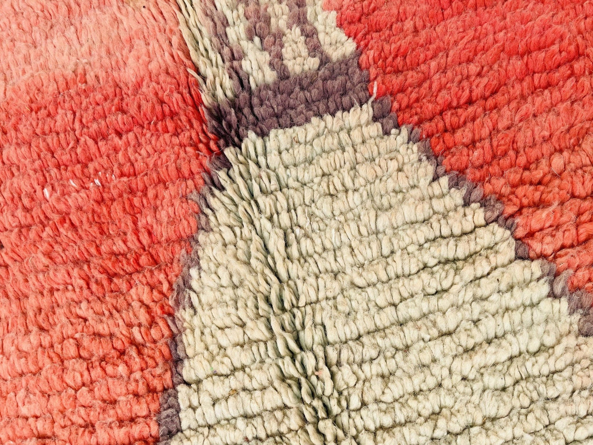 Detail shot of the colorful pattern on the orange geometric Beni Ourain Moroccan rug.
