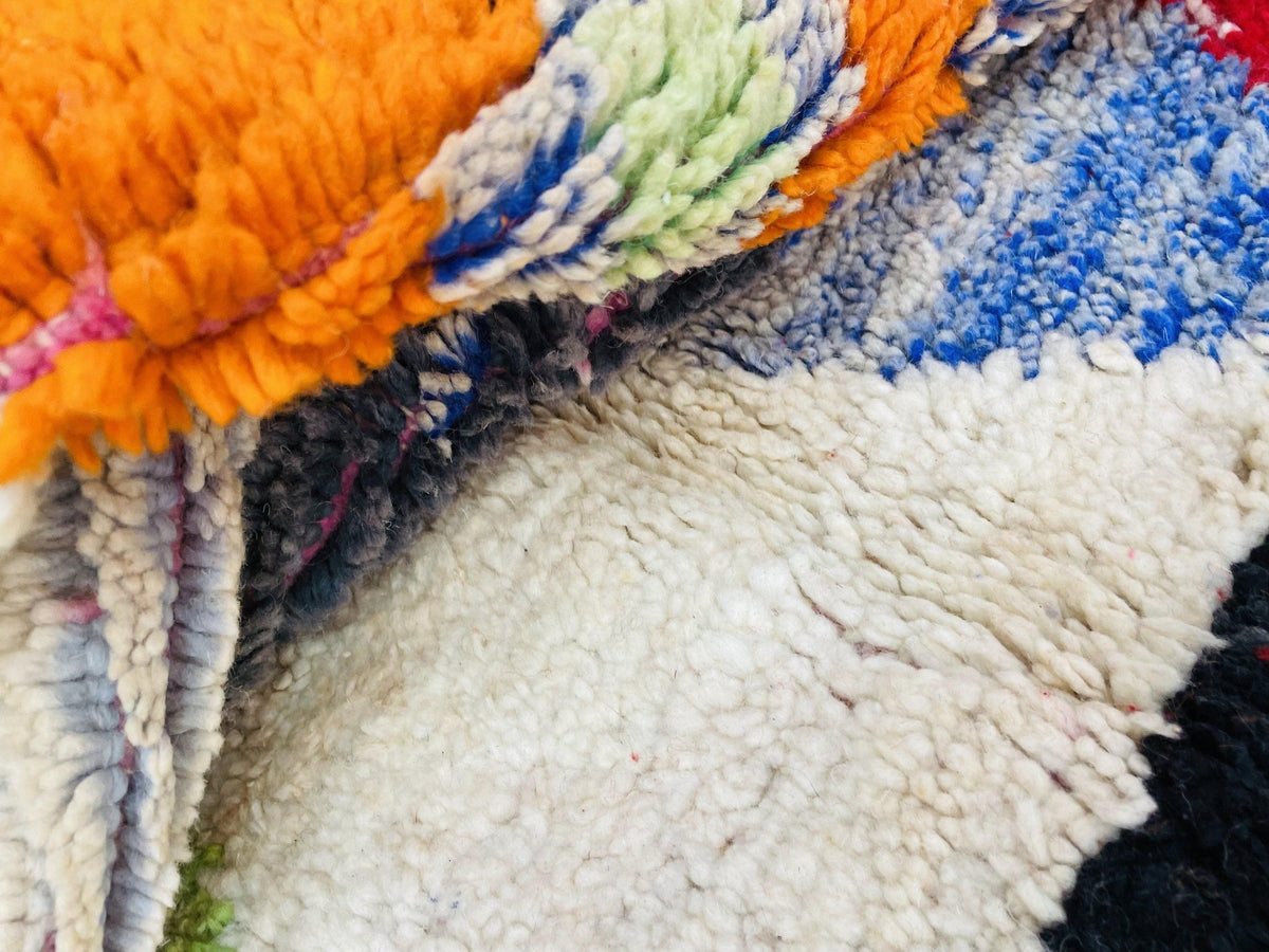 Top view of an orange abstract Moroccan rug showcasing its vibrant colors and geometric patterns.