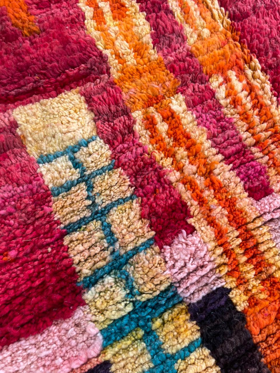Detail view of a colorful Berber rug featuring vibrant colors and textured patterns.