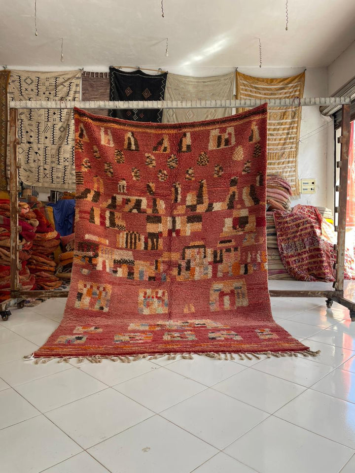 Lifestyle shot of a colorful pink vintage Boujaad Moroccan rug with geometric patterns.