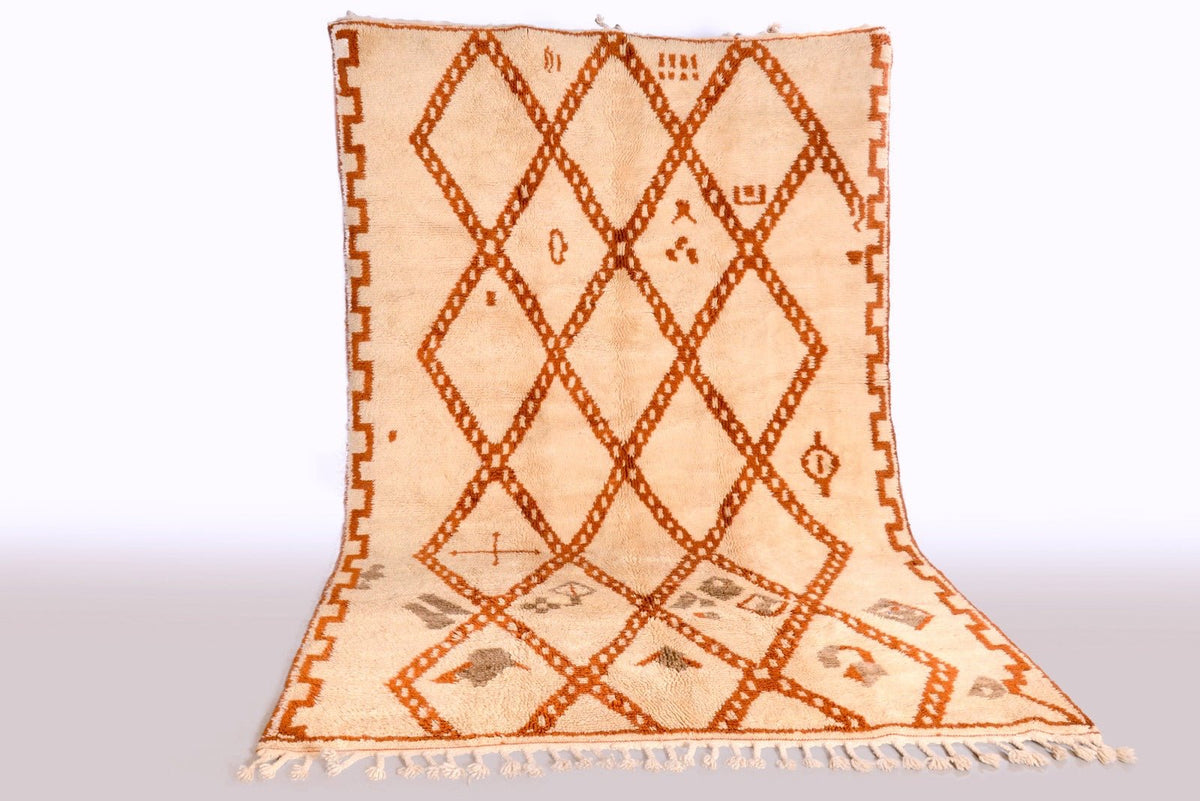 Lifestyle shot of a beige and brown Beni Ourain rug featuring a diamond design.