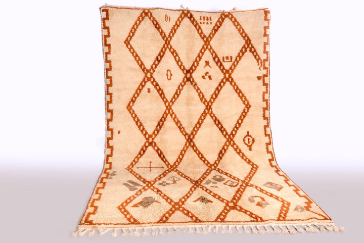 Lifestyle shot of a beige and brown Beni Ourain rug featuring a diamond design.