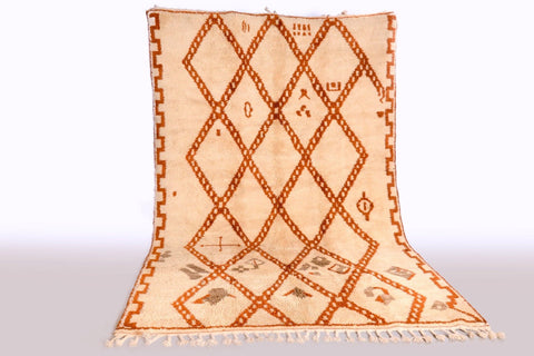Lifestyle shot of a beige and brown Beni Ourain rug featuring a diamond design.