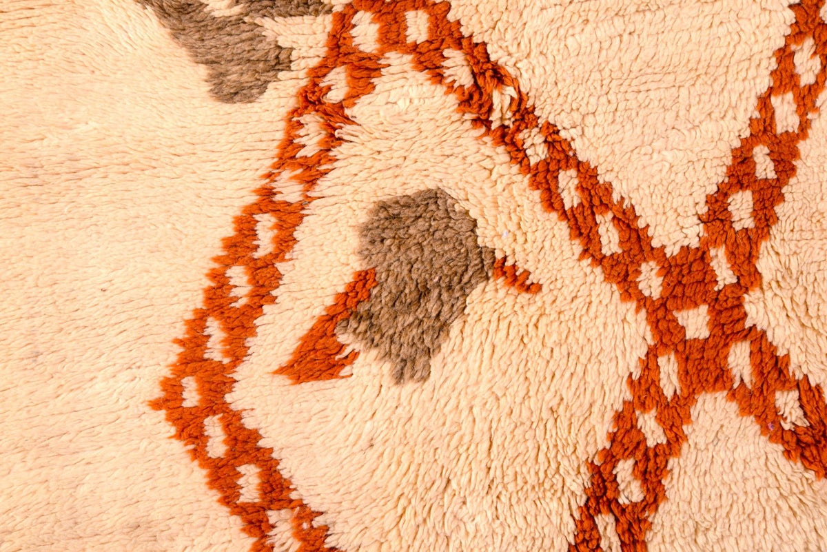 Detailed view of a brown diamond rug with a soft texture and geometric patterns.