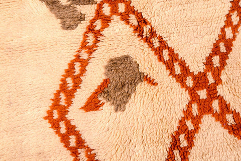 Detailed view of a brown diamond rug with a soft texture and geometric patterns.