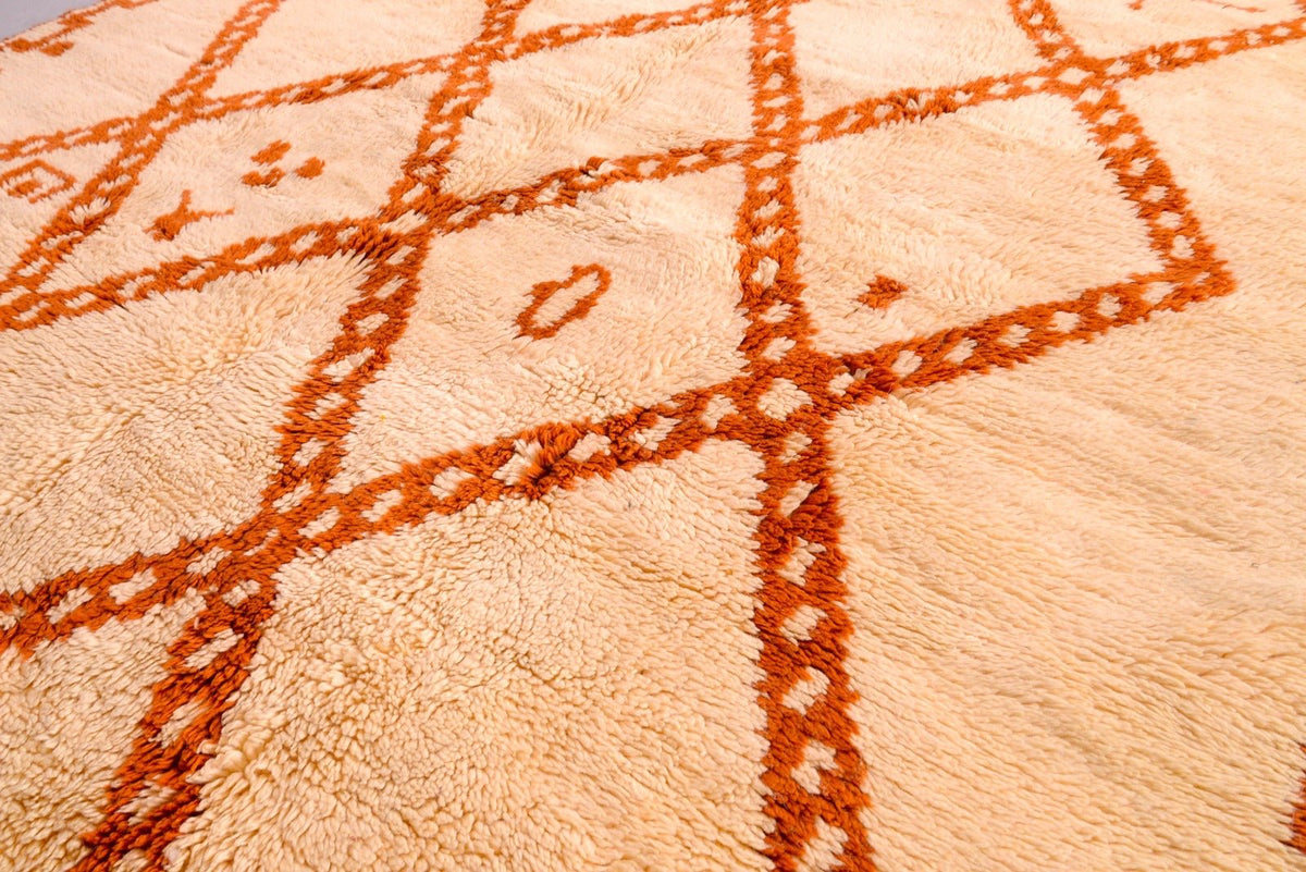 Close-up detail of a beige and brown Beni Ourain rug with geometric patterns.