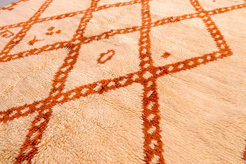 Close-up detail of a beige and brown Beni Ourain rug with geometric patterns.