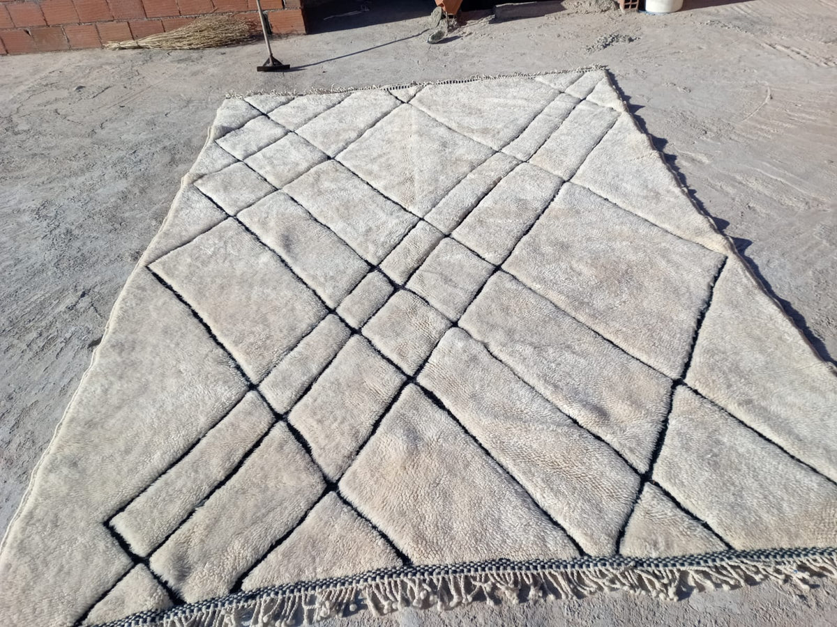 Front view of a white Moroccan rug showcasing its tufted texture and geometric design.