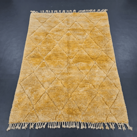 Front view of the mustard yellow Moroccan rug highlighting its design and fringe edges.