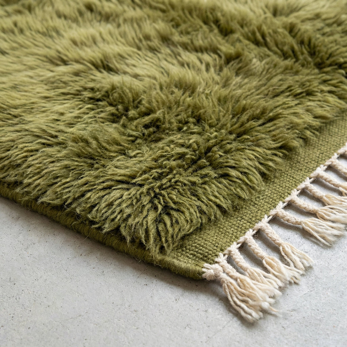 Front view of the olive green Moroccan rug showcasing its tribal pattern against a white backdrop.