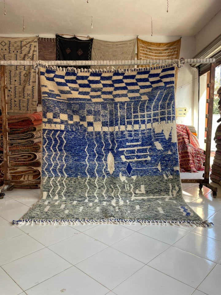 Lifestyle shot of a vintage Moroccan rug featuring blue and green colors with a Berber design.