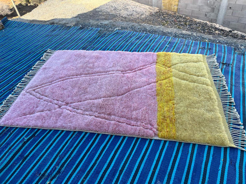 Front view of the pink and yellow Mrirt Moroccan rug with visible fringe edges.