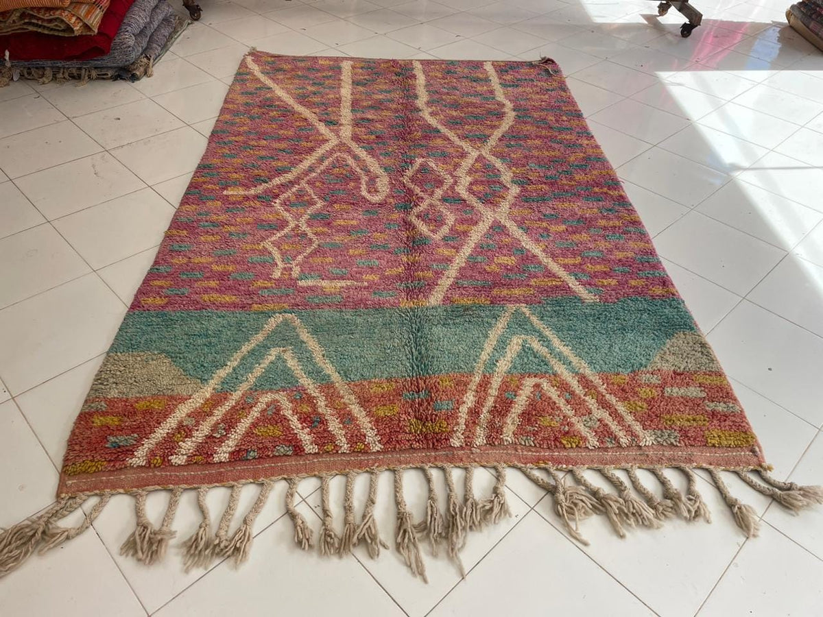 Front view of the pink vintage Moroccan rug featuring geometric patterns and vibrant colors.