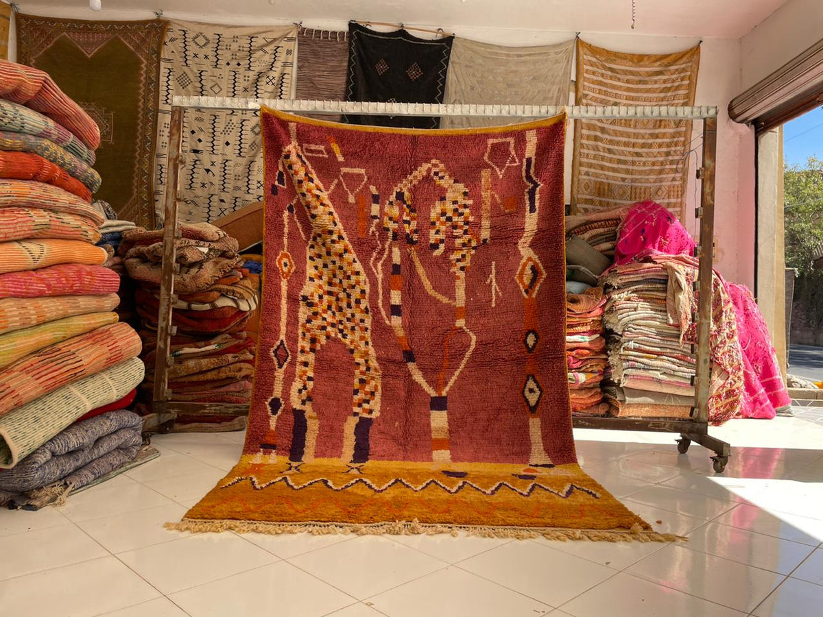 Lifestyle shot of a vintage Moroccan rug featuring geometric patterns in a natural setting.