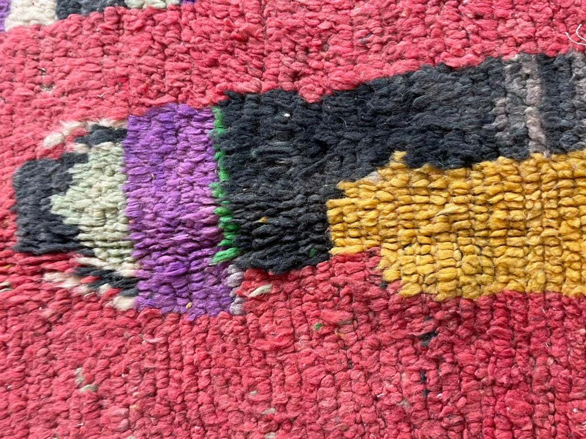 Detail view of the vintage Moroccan rug with tribal patterns and rich colors.
