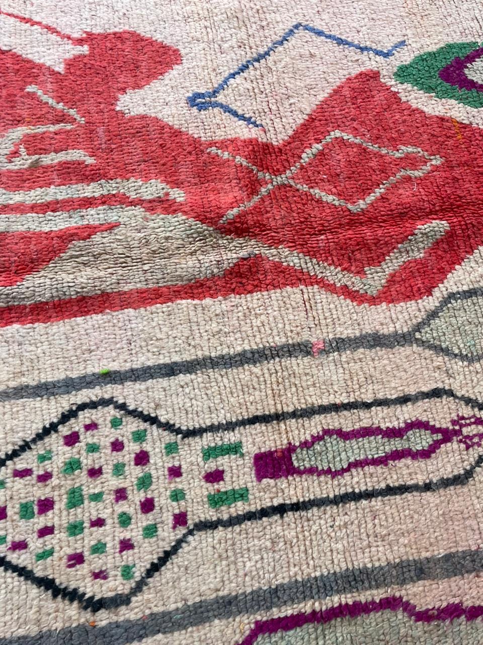 Detail close-up of a vintage Moroccan rug highlighting intricate designs and fringe edges.