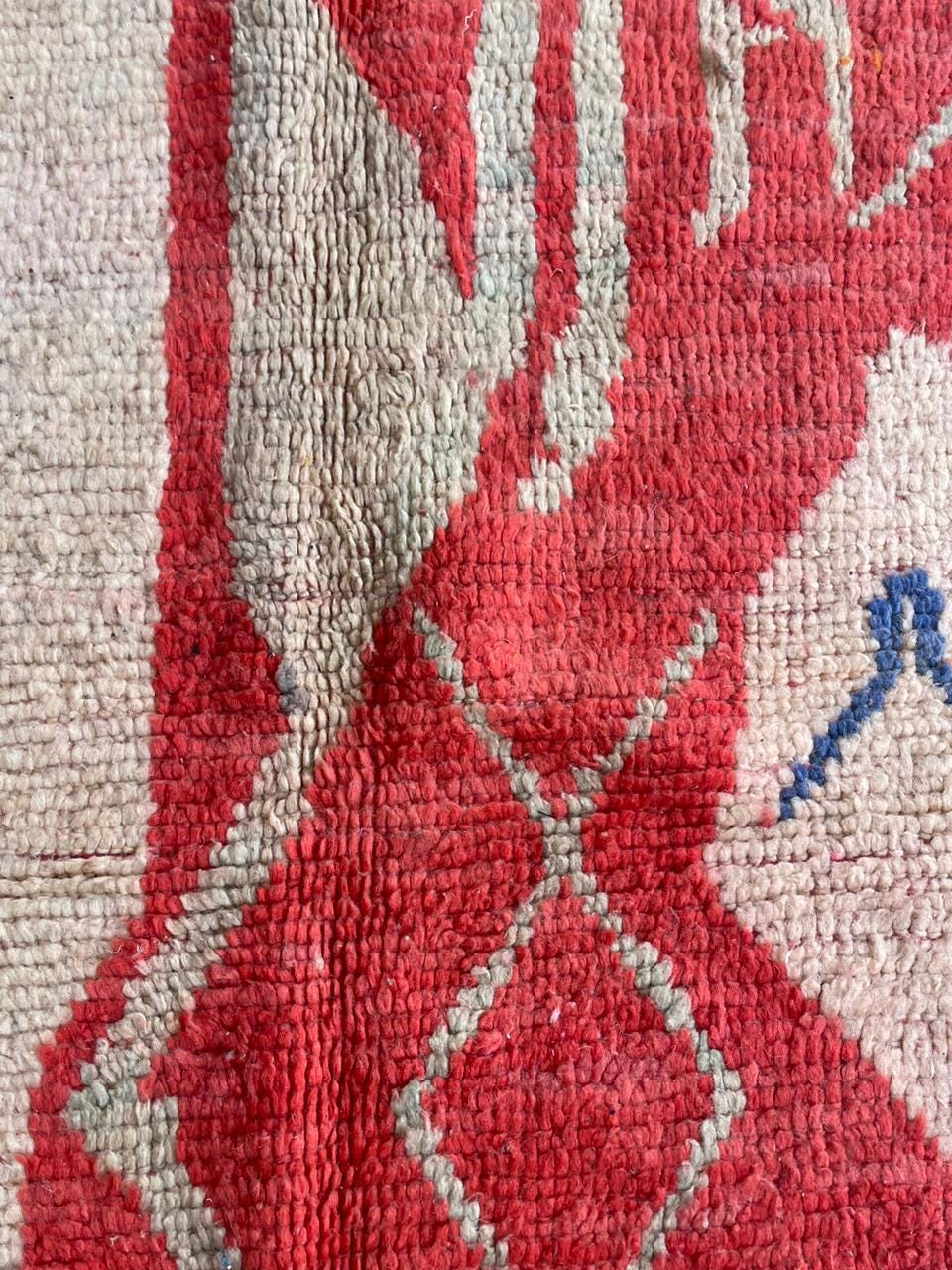 Detail shot of a vintage Moroccan rug featuring a geometric design and woven texture.
