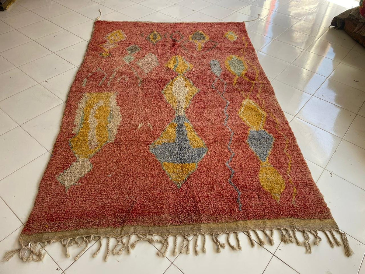 Front view of a red vintage Moroccan rug showcasing its abstract design and vibrant colors.