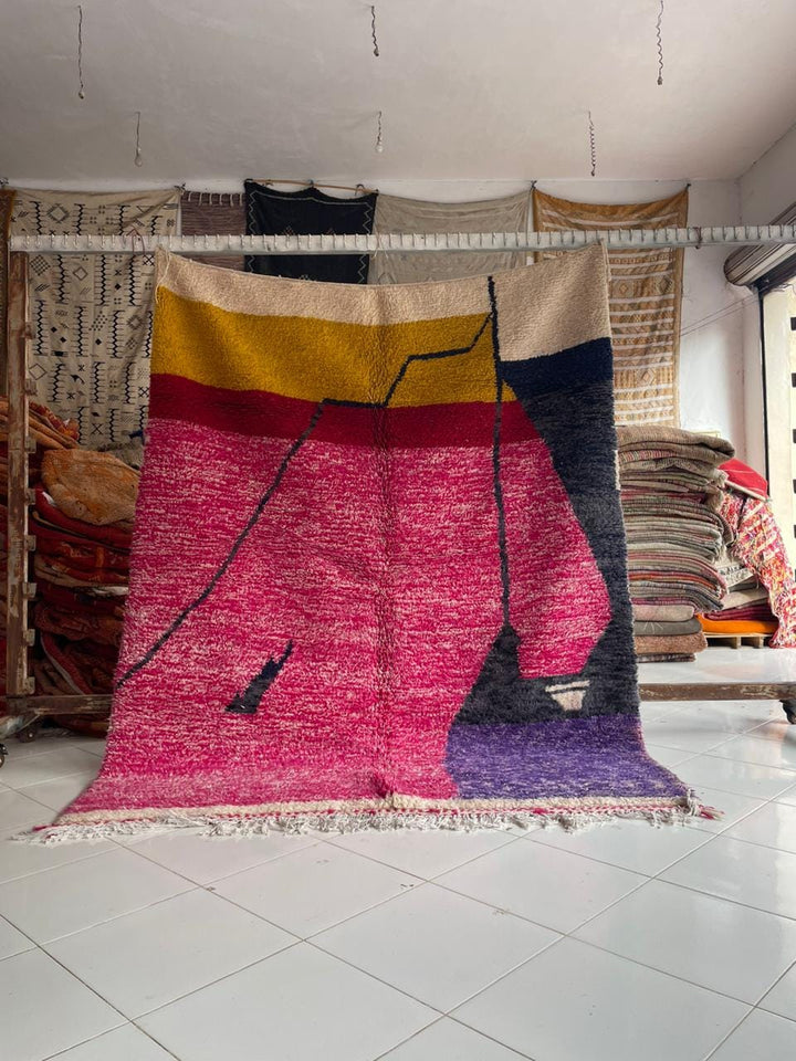 Lifestyle shot of a vintage Moroccan rug in violet, pink, and yellow colors.