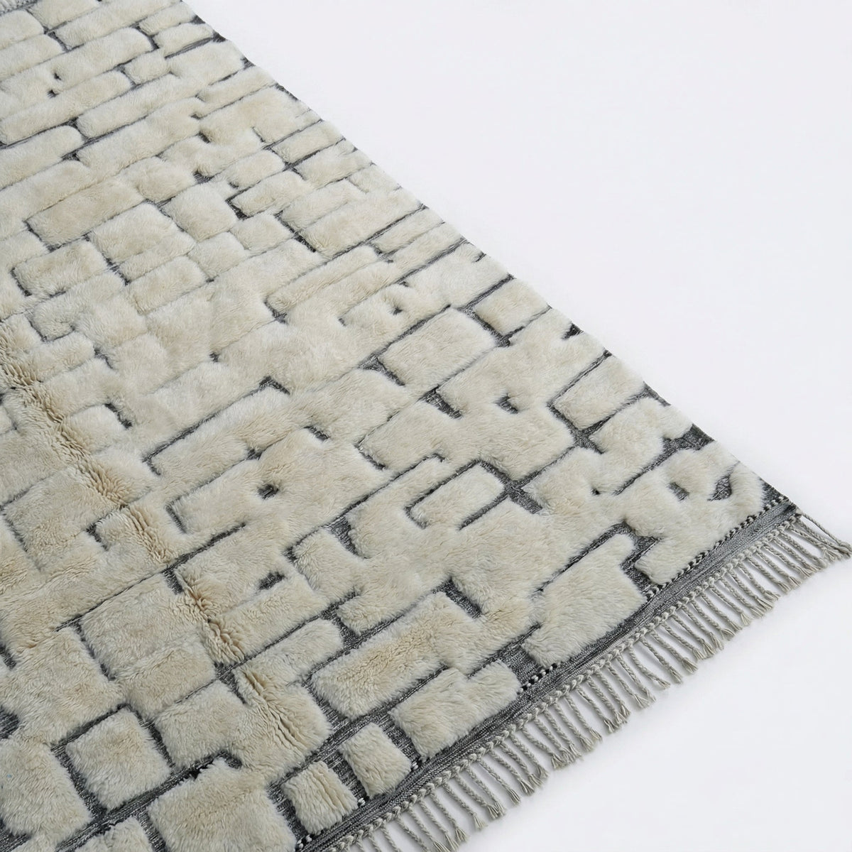 Front view of the cream Moroccan rug highlighting tufted texture and brick pattern against a white backdrop.