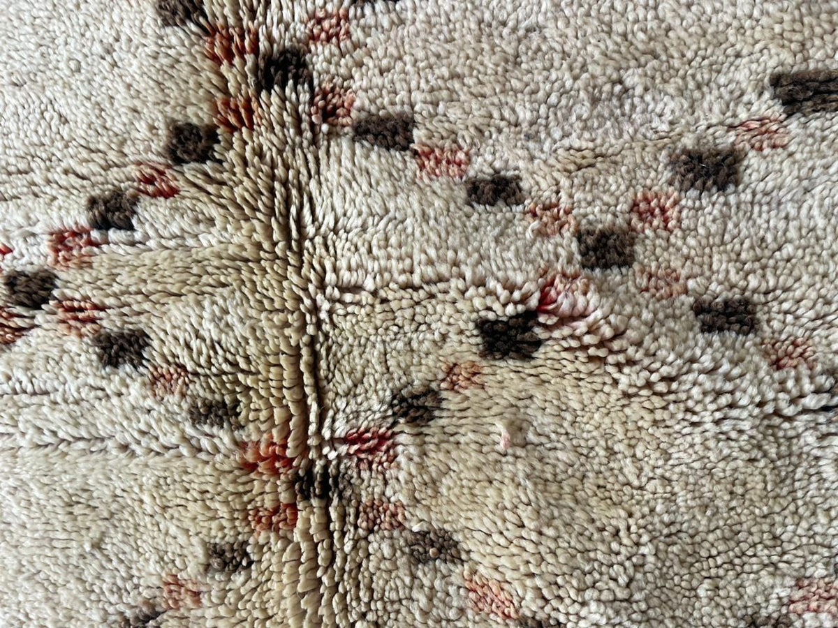 Close-up detail of a textured surface featuring geometric design in white, black, and red.