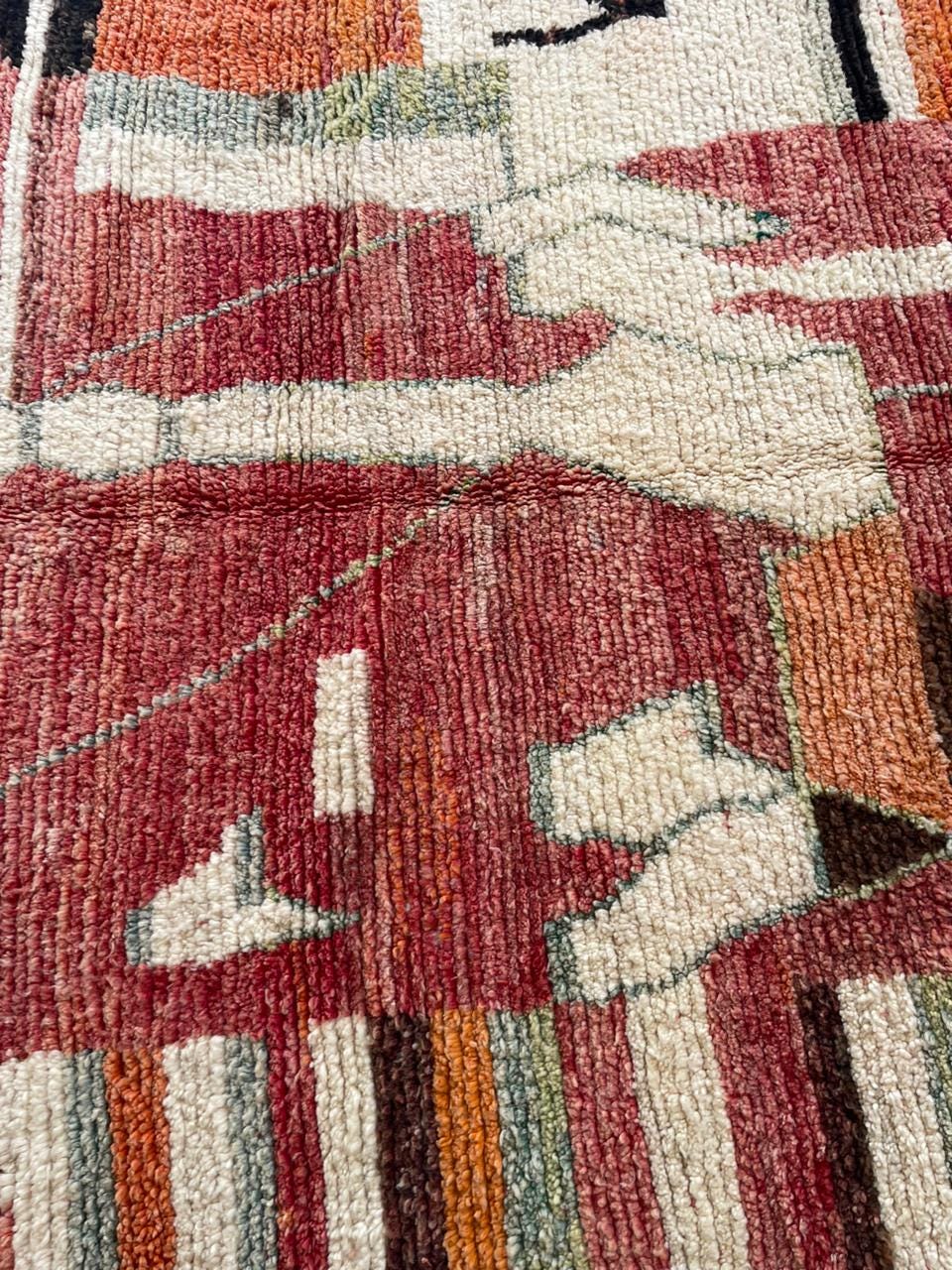Detail shot of a vintage rug displaying geometric patterns and a textured surface.