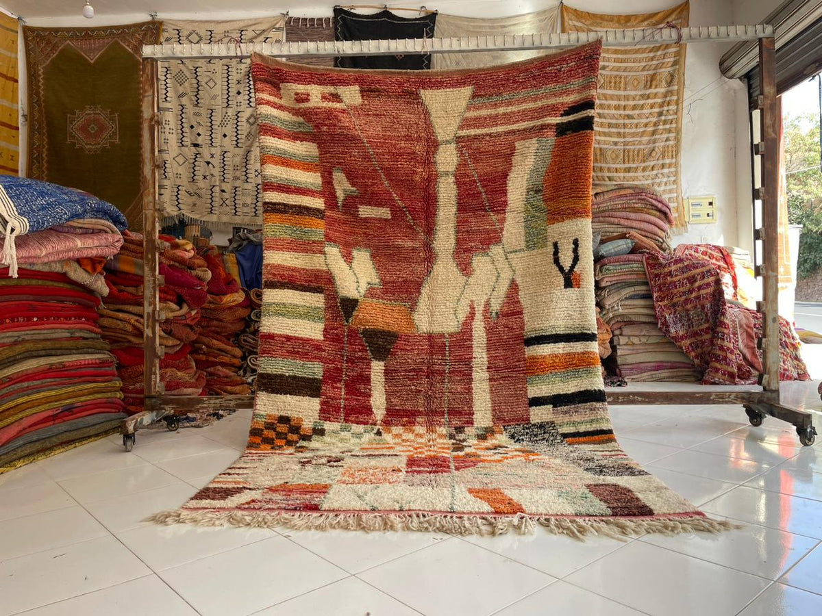 Lifestyle shot of a vintage rug with geometric designs in a studio setting.