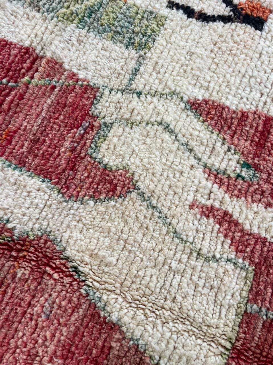 Close-up detail of the textured weave and abstract design of the vintage rug.