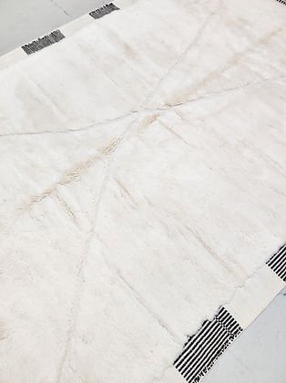 Close-up detail of a white and black tufted rug showcasing modern design elements