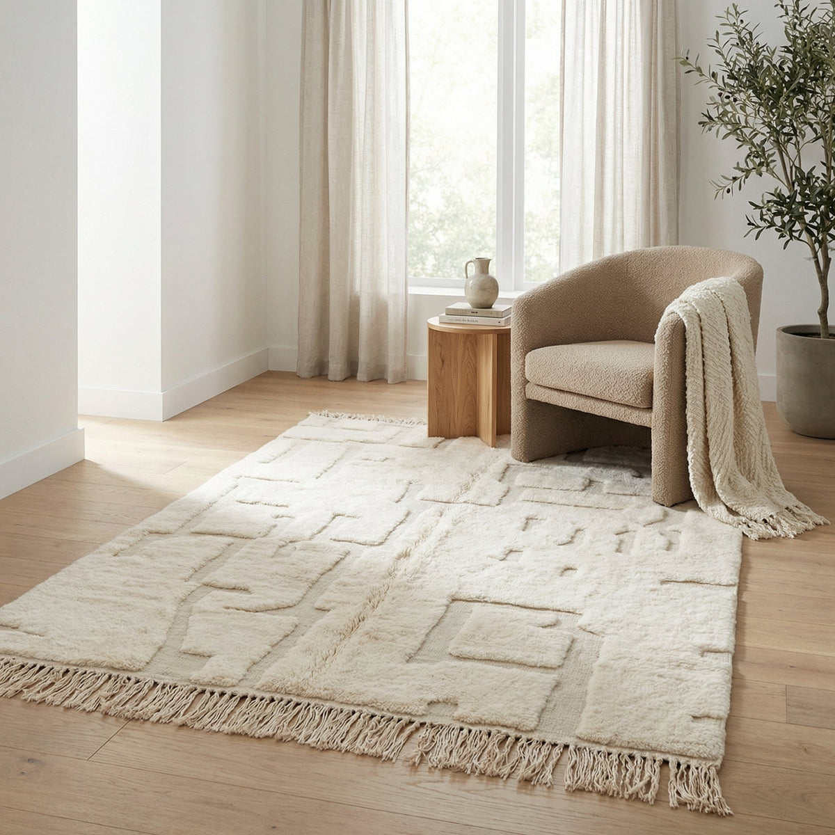 Lifestyle image of a white and beige Moroccan rug with geometric patterns in a natural setting.