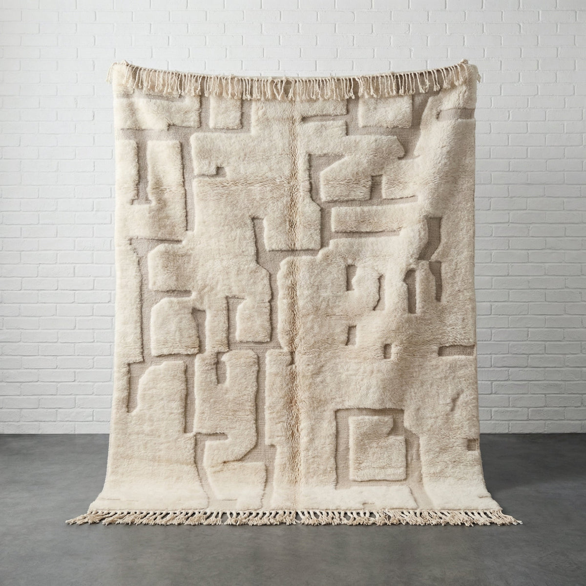 Lifestyle shot of a white and beige geometric patterned Moroccan rug in a natural setting.