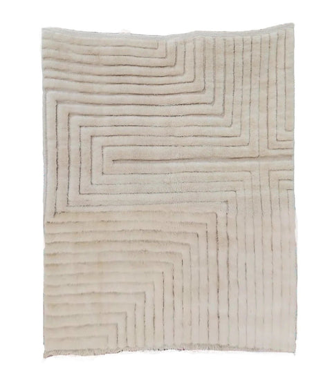 Front view of a white tufted Moroccan rug featuring a geometric pattern on a white background.