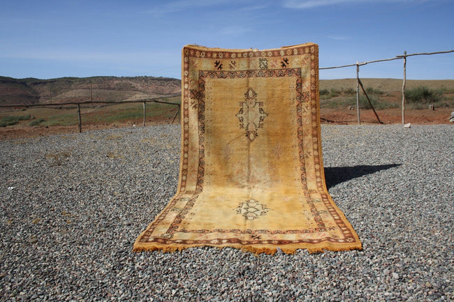 Lifestyle shot of a vintage kilim rug with intricate patterns in brown and beige.